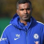 Vinay Menon at Chelsea training wearing a Chelsea jacket