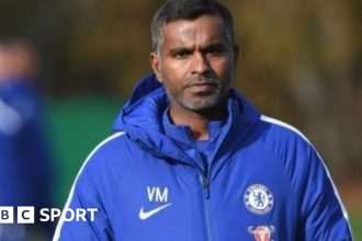 Vinay Menon at Chelsea training wearing a Chelsea jacket