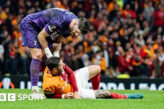 Tottenham keeper Fraser Forster checks on Mauro Icardi as the Galatasaray striker lies injured on the ground